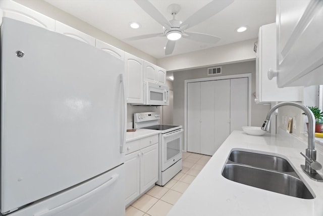 kitchen featuring sink, white cabinetry, light tile patterned floors, ceiling fan, and white appliances