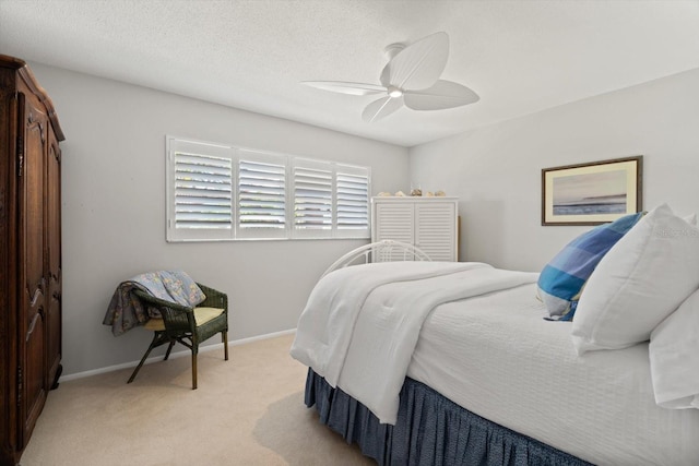 bedroom with light carpet, a textured ceiling, and ceiling fan