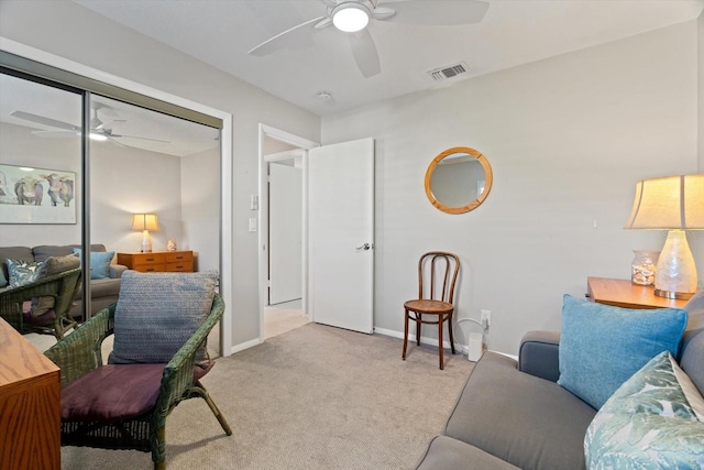 carpeted office space featuring ceiling fan