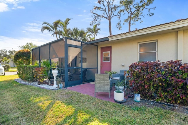 doorway to property featuring a yard and a patio area