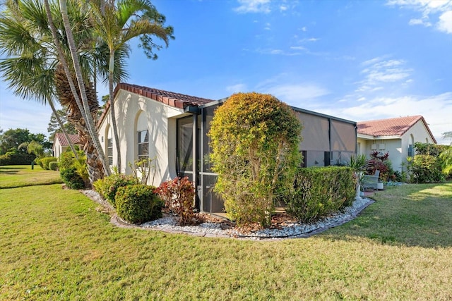 view of side of property with a lawn