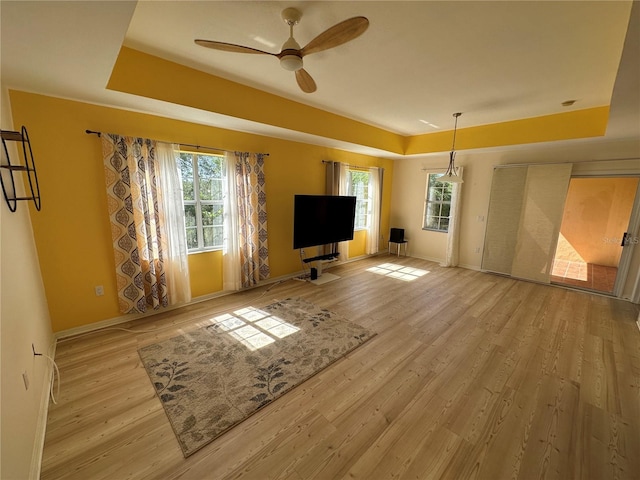 unfurnished living room featuring ceiling fan and light hardwood / wood-style floors