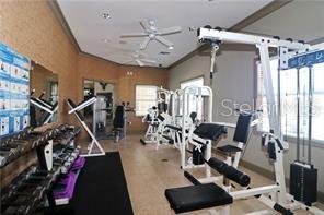 gym featuring plenty of natural light and ornamental molding