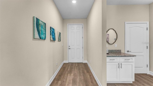 corridor with light hardwood / wood-style floors