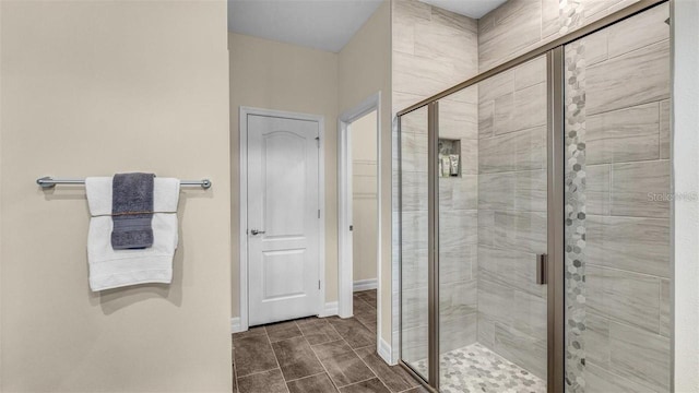 bathroom featuring a shower with shower door