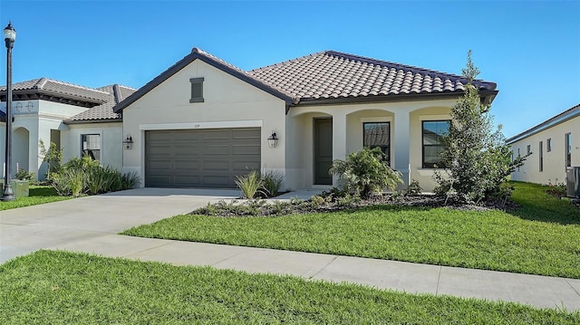 mediterranean / spanish house featuring a front yard, a garage, and central AC