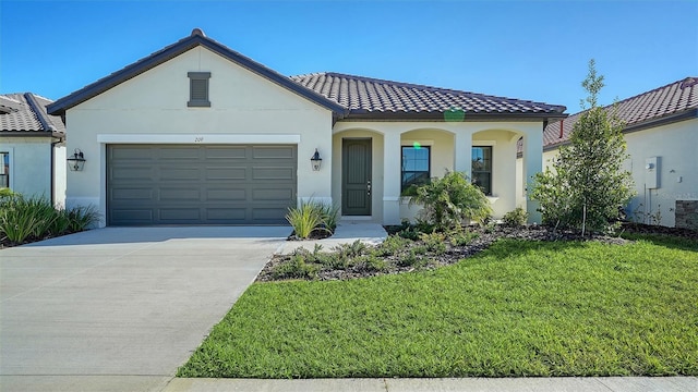 mediterranean / spanish house featuring a front lawn and a garage