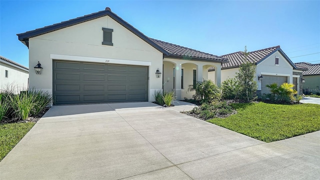 view of front of property featuring a garage and a front yard