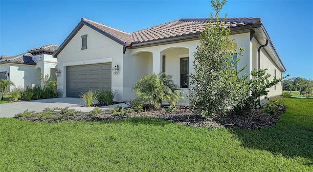 mediterranean / spanish-style home featuring a front lawn and a garage