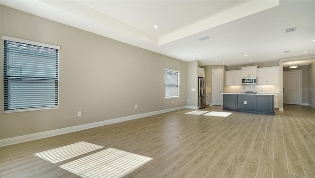 unfurnished living room featuring light hardwood / wood-style floors