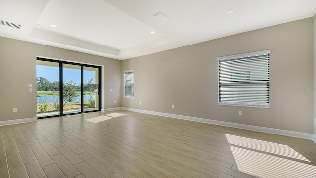 spare room with a tray ceiling