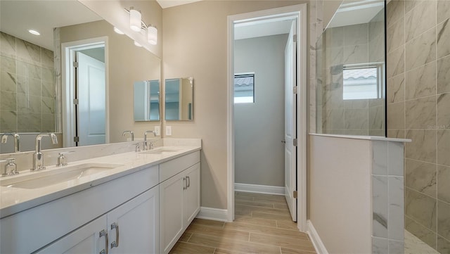 bathroom featuring tiled shower and vanity