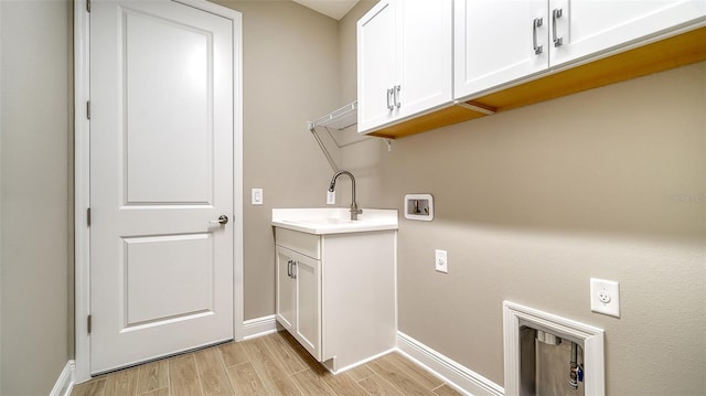 laundry area with cabinets, washer hookup, sink, and hookup for an electric dryer