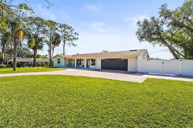 ranch-style house featuring a garage and a front lawn