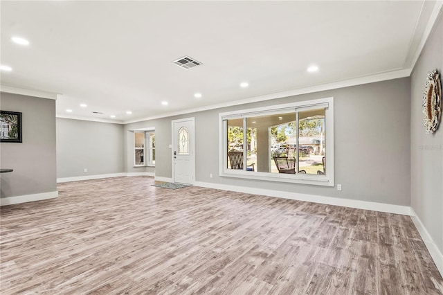 unfurnished living room featuring crown molding and light hardwood / wood-style flooring