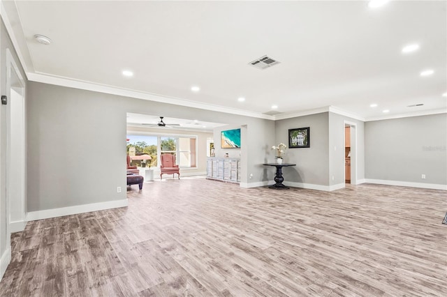 unfurnished living room featuring ornamental molding and light wood-type flooring