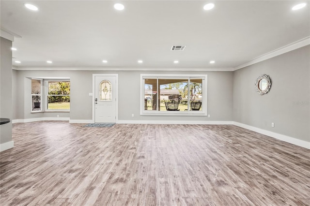 unfurnished living room featuring ornamental molding and light hardwood / wood-style floors