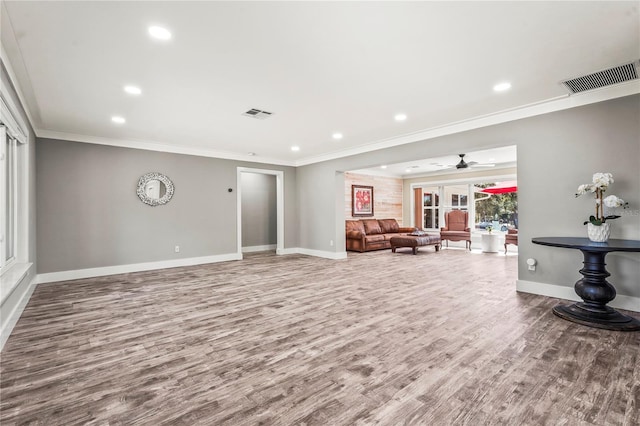 living room with hardwood / wood-style flooring, ceiling fan, and crown molding