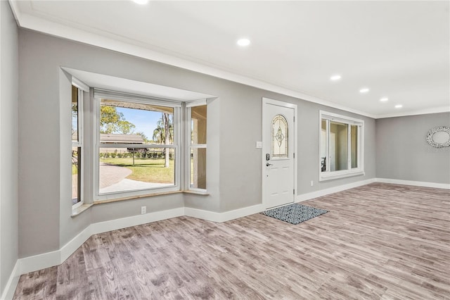 entrance foyer featuring hardwood / wood-style floors and crown molding