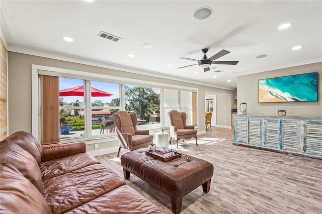 living room featuring ornamental molding, ceiling fan, and light hardwood / wood-style flooring