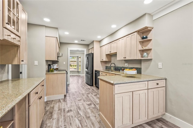 kitchen with dishwasher, light brown cabinetry, electric range, and refrigerator