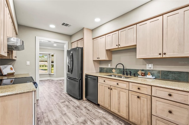 kitchen featuring sink, light hardwood / wood-style flooring, appliances with stainless steel finishes, light stone counters, and light brown cabinetry