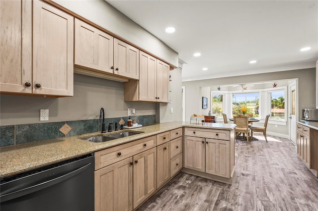 kitchen with dark hardwood / wood-style floors, dishwasher, sink, kitchen peninsula, and light brown cabinets