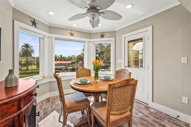 dining room featuring light hardwood / wood-style flooring, ornamental molding, and ceiling fan