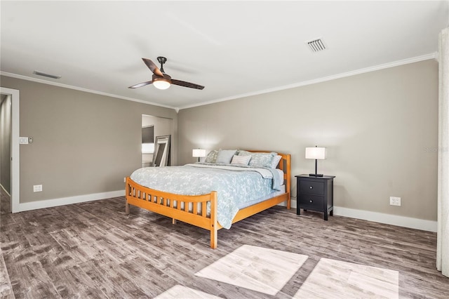 bedroom with hardwood / wood-style flooring, ceiling fan, and ornamental molding