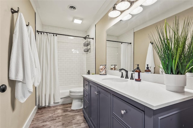 bathroom featuring vanity, wood-type flooring, toilet, and walk in shower