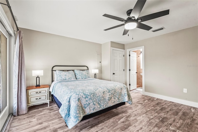 bedroom featuring ensuite bathroom, ceiling fan, and light hardwood / wood-style flooring