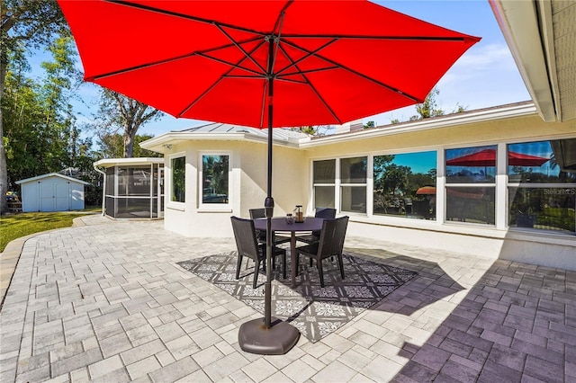 view of patio / terrace with a sunroom and a shed