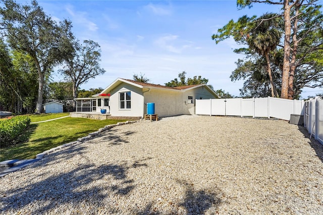 back of house with a lawn