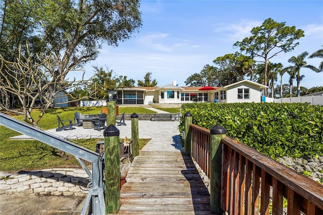 rear view of property with an outdoor fire pit and a patio