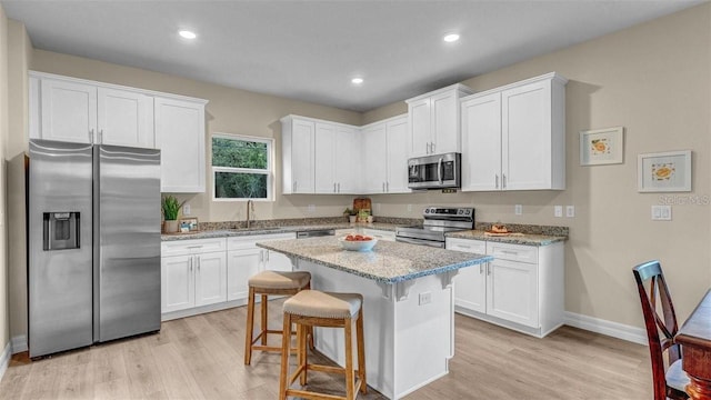 kitchen with white cabinetry, sink, and appliances with stainless steel finishes