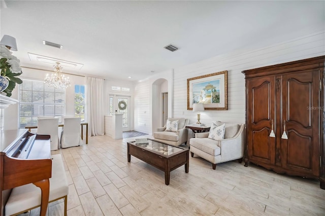 living room featuring an inviting chandelier and light wood-type flooring