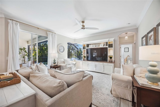 living room featuring ceiling fan and ornamental molding