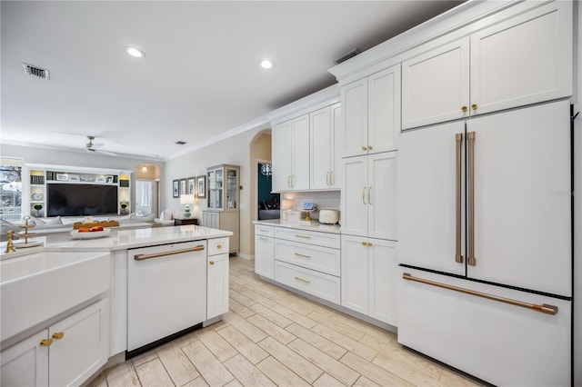 kitchen featuring ceiling fan, white appliances, a healthy amount of sunlight, and white cabinets