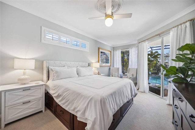 bedroom with ceiling fan, access to exterior, light carpet, and multiple windows