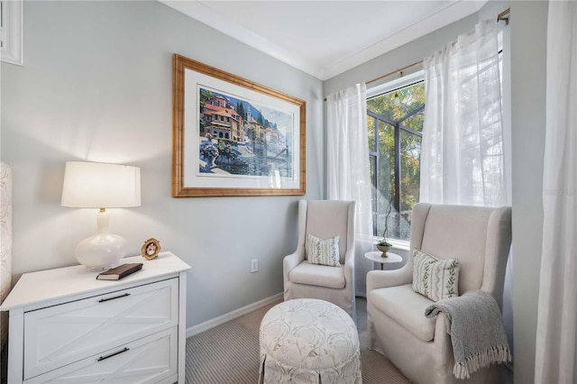 sitting room featuring carpet floors and ornamental molding