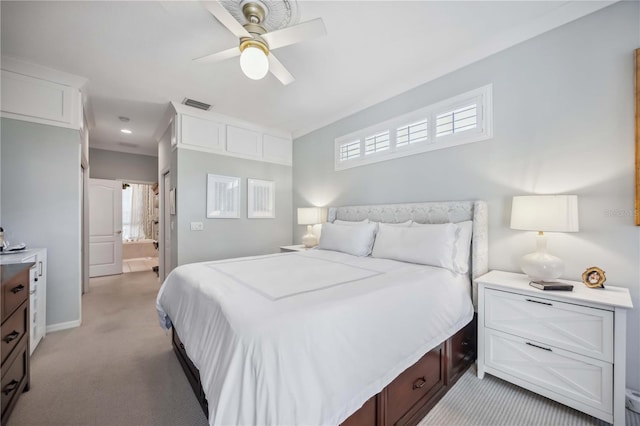 carpeted bedroom featuring ceiling fan and ensuite bathroom