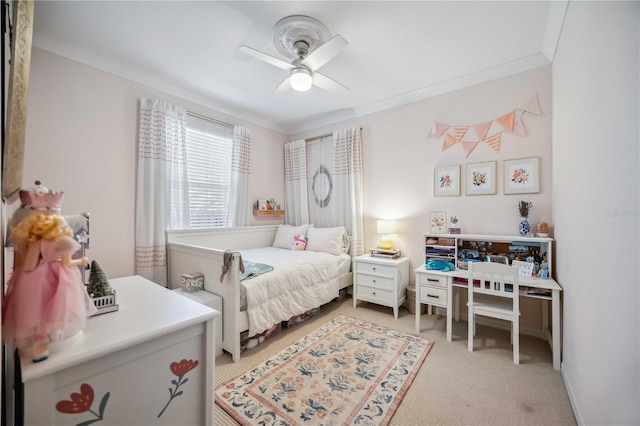 bedroom featuring light carpet, crown molding, and ceiling fan