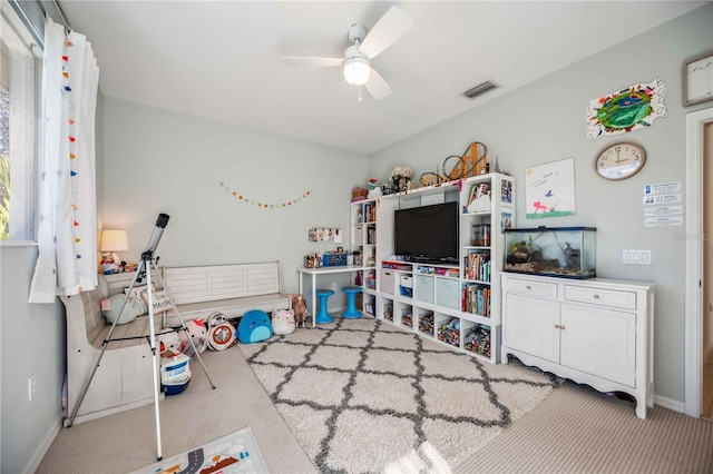 game room with ceiling fan and light colored carpet