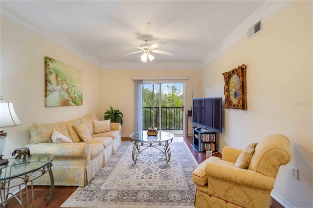 living room with ceiling fan, ornamental molding, and wood-type flooring