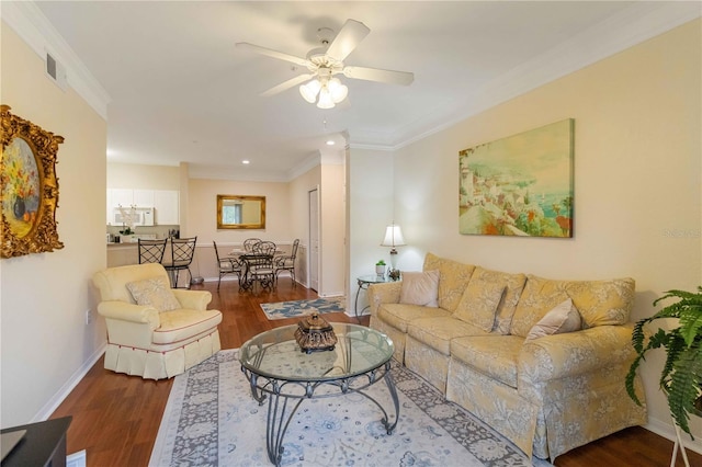 living room featuring ceiling fan, ornamental molding, and dark wood-type flooring