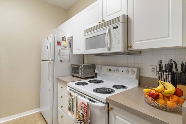 kitchen featuring light tile patterned flooring, white appliances, decorative backsplash, and white cabinets