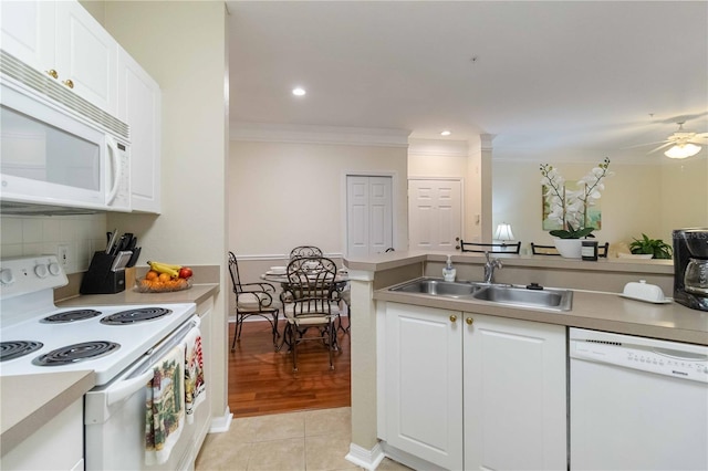 kitchen with sink, light tile patterned flooring, white appliances, and white cabinetry