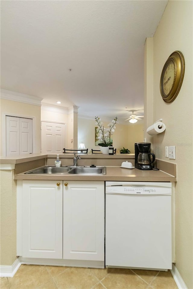 kitchen featuring crown molding, dishwasher, sink, white cabinetry, and light tile patterned floors