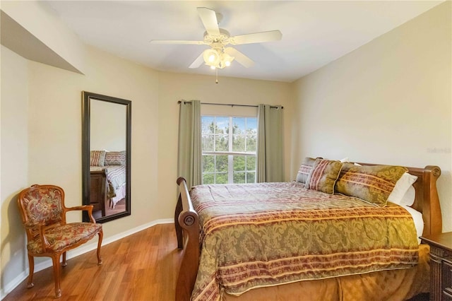 bedroom with hardwood / wood-style flooring and ceiling fan