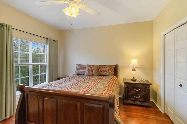 bedroom featuring hardwood / wood-style floors, a closet, and ceiling fan